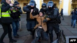 Police officers detain a man during a protest against Russian military action in Ukraine, in central St. Petersburg, Russia, March 13, 2022.