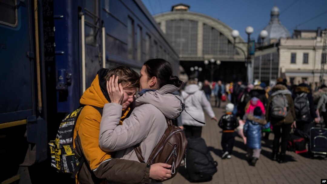 A mother embraces her son who escaped the besieged city of Mariupol and arrived at the train station in Lviv, western Ukraine, March 20, 2022.