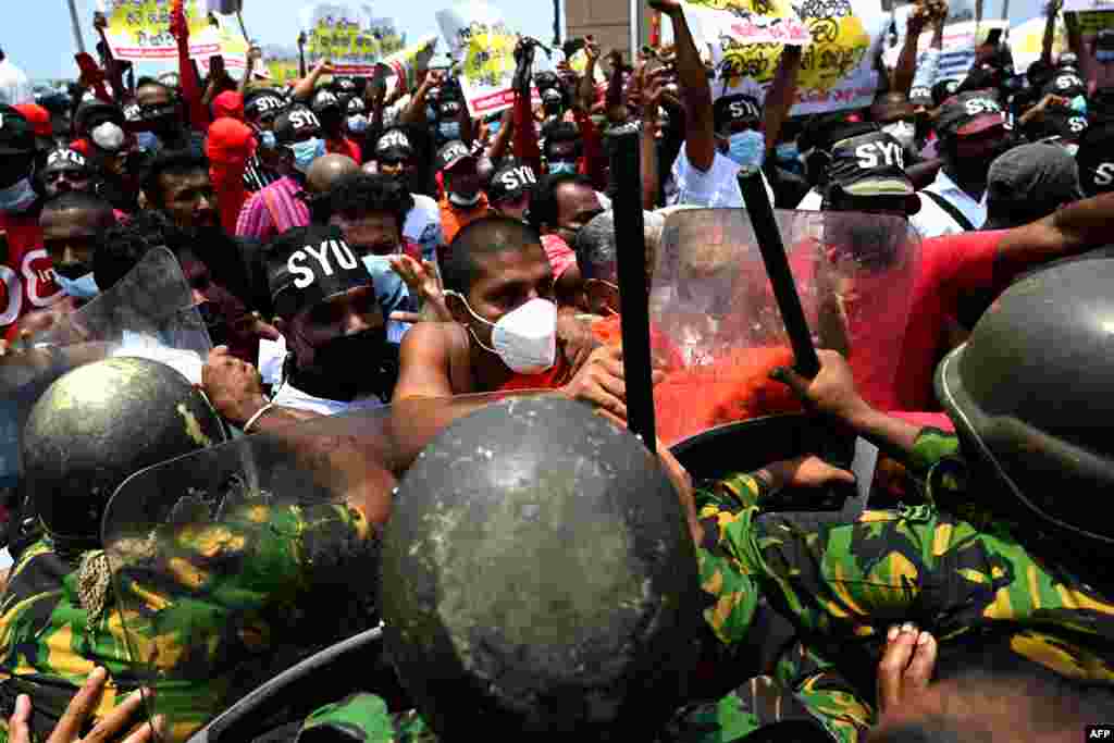 Police Special Task Force officers try to stop demonstrators during a protest against the rising living costs, outside President Gotabaya Rajapaksa&#39;s seafront office in Colombo, Sri Lanka.