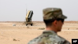 FILE - A member of the U.S. Air Force stands near a Patriot missile battery at the Prince Sultan air base in al-Kharj, central Saudi Arabia, on February 20, 2020. 