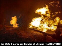 Facilities of a complex that prepares natural gas for transportation are pictured in a fire after night shelling, as Russia's attack on Ukraine continues, in the village of Hlazunivka in Kharkiv region, Ukraine, in this handout picture released March 13,