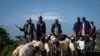 FILE - Masai men bringing goats to a livestock market to sell in Kimana, March 2, 2021.