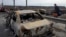 A resident passes by cars burnt in the Russian shellfire as he flees from his hometown Irpin on the road toward the capital Kyiv, Ukraine, March 12, 2022.
