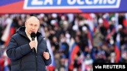 Russian President Vladimir Putin delivers a speech during a rally at Luzhniki Stadium in Moscow, March 18, 2022. The banner reads: "For Russia," using the untraditional "Z" representative of Russia's campaign in Ukraine. (Sputnik/Kremlin via Reuters)