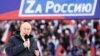 Russian President Vladimir Putin delivers a speech during a rally at Luzhniki Stadium in Moscow, March 18, 2022. The banner reads: "For Russia," using the untraditional "Z" representative of Russia's campaign in Ukraine. (Sputnik/Kremlin via Reuters)