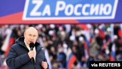 Russian President Vladimir Putin delivers a speech during a rally at Luzhniki Stadium in Moscow, March 18, 2022. The banner reads: "For Russia," using the untraditional "Z" representative of Russia's campaign in Ukraine. (Sputnik/Kremlin via Reuters)