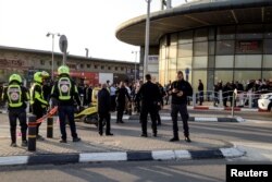 Israeli security and rescue forces secure the scene of a deadly attack near a shopping center in Beersheba, Israel, March 22, 2022.