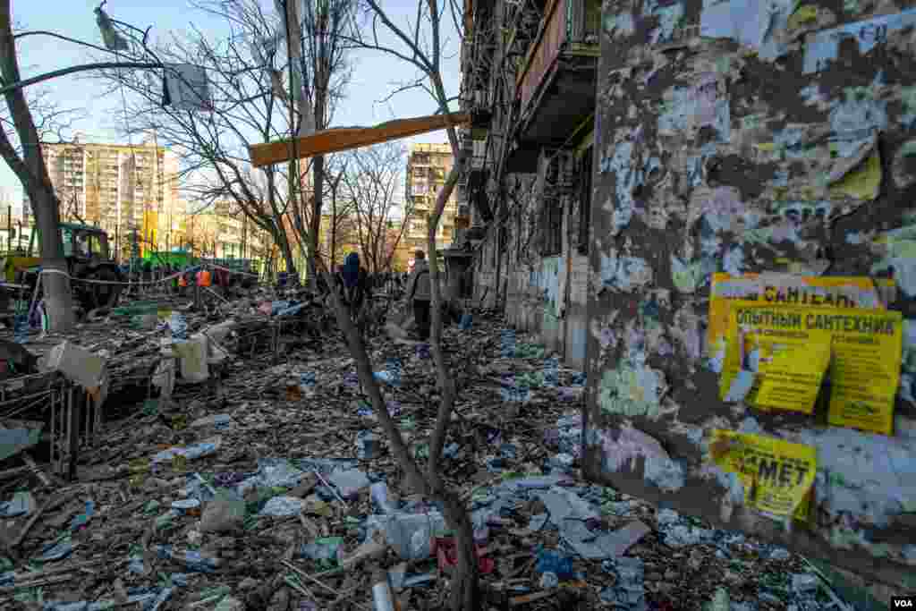 Debris is scattered alongside the front of this nine-floor residential building that was struck by a missile in Kyiv, Ukraine, March 14, 2022.