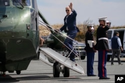 U.S. President Joe Biden boards Marine One in Rehoboth Beach, Delaware, en route to Washington, on March 20, 2022.