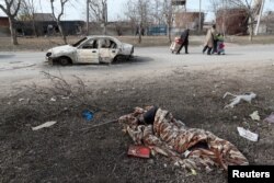 A view shows the body of a person killed during Ukraine-Russia conflict in the besieged southern port of Mariupol, Ukraine, March 20, 2022.