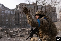 A Ukrainian serviceman guards his position in Mariupol, Ukraine, Saturday, March 12, 2022. (AP Photo/Mstyslav Chernov)