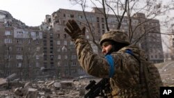 A Ukrainian serviceman guards his position in Mariupol, Ukraine, Saturday, March 12, 2022. (AP Photo/Mstyslav Chernov)