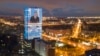 FILE - An electronic screen, installed on the facade of a business tower, shows an image of Russian President Vladimir Putin speaking during his annual state of the nation address, in St. Petersburg, Russia, April 21, 2021.