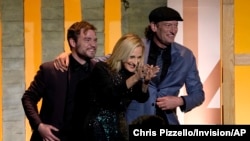 From left, Daniel Durant, Marlee Matlin and Troy Kotsur appear on stage as the producing team of "Coda" accepts the Darryl F. Zanuck Award for Outstanding Producer of Theatrical Motion Pictures at the 33rd annual Producers Guild Awards, March 19, 2022.