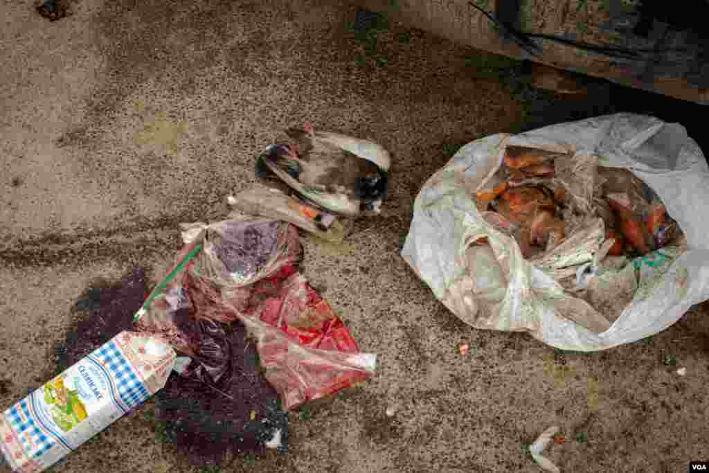 Food, blood and a beheaded pigeon are seen on the bridge that links Irpin to Kyiv, in Irpin, Ukraine, March 13, 2022.