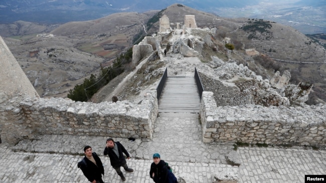 Franco Cagnoli, 39, caretaker of the Rocca Calascio castle explains to tourists the history of the castle, February 25, 2022. (REUTERS/Remo Casilli)