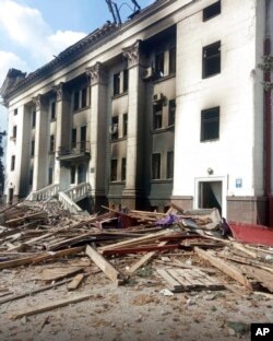 This image made available by Azov Battalion shows a drama theater that was damaged by shelling, in Mariupol, Ukraine, March 17, 2022. Rescuers continued to search for survivors in the ruins of the theater ripped apart by Russian airstrikes.