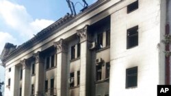 This image made available by Azov Battalion shows a drama theater that was damaged by shelling, in Mariupol, Ukraine, March 17, 2022. Rescuers continued to search for survivors in the ruins of the theater ripped apart by Russian airstrikes.