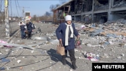 People flee the Russia's invasion of Ukraine, in Bucha, Ukraine March 12, 2022 in this screen grab taken from a handout video. Video taken March 12, 2022. ICRC/Handout via REUTERS.