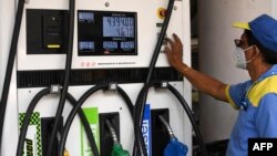 FILE - An attendant prints a payment receipt at a fuel station in Mumbai, March 7, 2022.