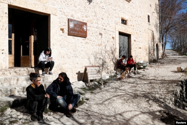 Residents of Rocca Calascio enjoy a sunny day in the small village of Rocca Calascio, Italy, February 25, 2022. (REUTERS/Remo Casilli)