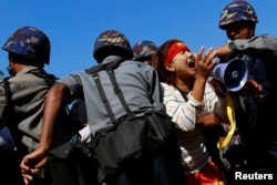 FILE - Police restrain student Ei Thinzar Maung during a protest against an education bill in Letpadan, Bago division, March 6, 2015.