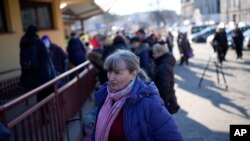 A woman joins a line to board a train leaving for Lviv in Ukraine at the train station in Przemysl, Poland, March 14, 2022.