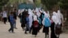 FILE - Afghan students leave school classes in a primary school in Kabul, Afghanistan on March 27, 2021. 