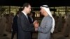 In this photo released by the official Facebook page of the Syrian Presidency, Syrian President Bashar Assad, left, speaks with Abu Dhabi's Crown Prince, Sheikh Mohammed bin Zayed Al Nahyan, in Abu Dhabi, United Arab Emirates, March 18, 2022. 