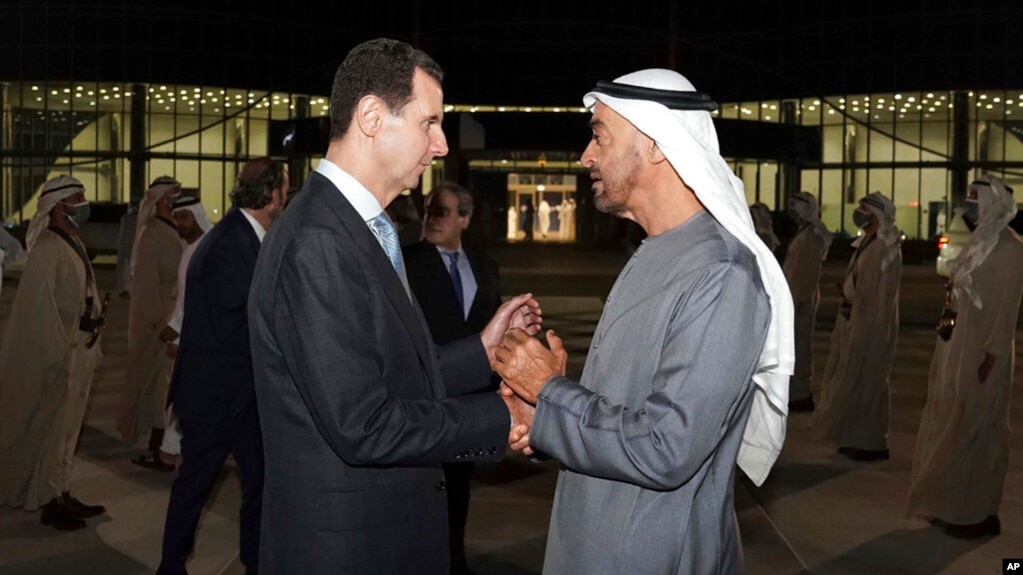 In this photo released by the official Facebook page of the Syrian Presidency, Syrian President Bashar Assad, left, speaks with Abu Dhabi's Crown Prince, Sheikh Mohammed bin Zayed Al Nahyan, in Abu Dhabi, United Arab Emirates, March 18, 2022. 