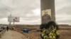 The picture of a fallen Ukrainian soldier is displayed on a light post at the bridge that links Irpin to Kyiv, in Ukraine, March 13, 2022. 