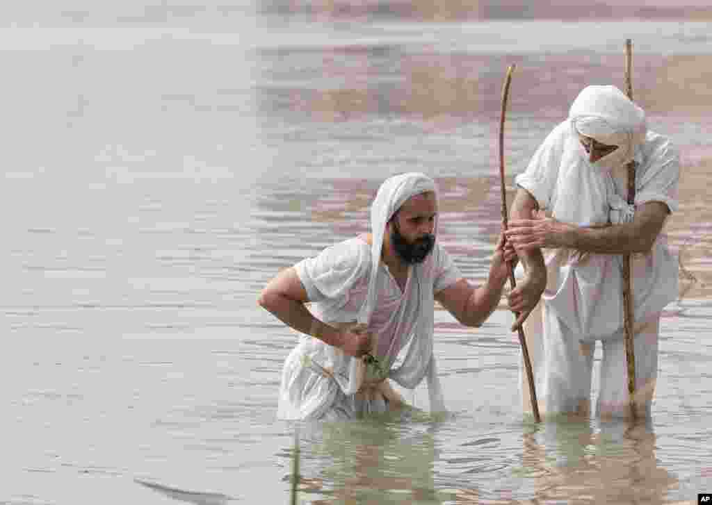 Followers of the Sabean Mandaeans faith, a pre-Christian sect that follows the teachings of the Bible&#39;s John the Baptist, perform their rituals in the Tigris River during a celebration marking &quot;Banja&quot; or Creation Feast, in central Baghdad, Iraq.