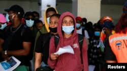 Nigerian students, who studied in Ukraine, arrive at Nnamdi Azikiwe International Airport after fleeing Russia's invasion of the country, in Abuja, Nigeria, March 4, 2022. Nigeria says that 80 of its students remain trapped in the southern city of Kherson.