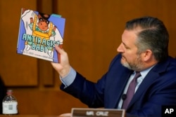 Sen. Ted Cruz, R-Texas, holds up a book as he questions Supreme Court nominee Judge Ketanji Brown Jackson on Capitol Hill, March 22, 2022.