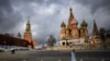 FILE - A woman walks near the Kremlin and St. Basil's Cathedral in central Moscow, Russia, Feb. 22, 2022. 