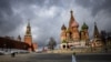 FILE - A woman walks near the Kremlin and St. Basil's Cathedral in central Moscow, Russia, Feb. 22, 2022. 