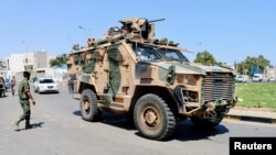 FILE: A military vehicle belonging to the Libyan armed unit 444 Brigade, backing the Government of National Unity (GNU) and Prime Minister Abdulhamid al-Dbeibah, drives in Ain Zara area in Tripoli, Libya, July 22, 2022. 