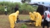 FILE - Health workers carry the body of an Ebola virus victim in the Waterloo district of Freetown, Sierra Leone. Burial teams are vulnerable to psychological stress. 