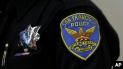 A patch and badge are seen on the uniform of a San Francisco police officer during a news conference Friday, April 29, 2016, in San Francisco. 