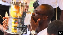 Students prepare to launch a soda-can sized satellite, at All Nations University, Koforidua, Ghana, May 15, 2013.