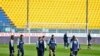 Parma's players warm up on the field moments before a Serie A soccer match between Parma and Spal was scheduled to be played, in Parma, northern Italy, March 8, 2020.