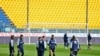 Parma's players warm up on the field moments before a Serie A soccer match between Parma and Spal was scheduled to be played, in Parma, northern Italy, March 8, 2020.