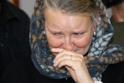 FILE - United Nations Humanitarian Coordinator in Yemen, Lise Grande, reacts as she visits children injured in an airstrike that killed dozens, mainly children, in Yemen's northern province of Saada, at a hospital in Saada, Yemen, Aug. 14, 2018.