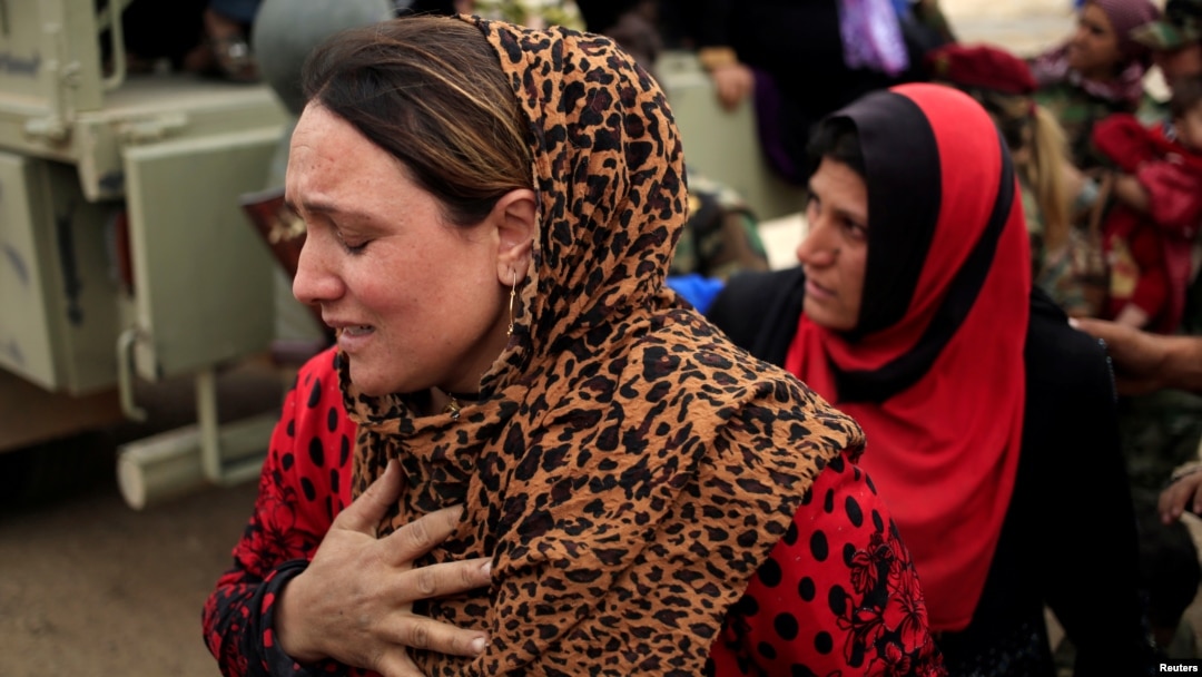 A newly internally displaced woman reacts upon her arrival at Al Khazar camp near Hassan Sham, east of Mosul, Iraq Oct. 28, 2016.