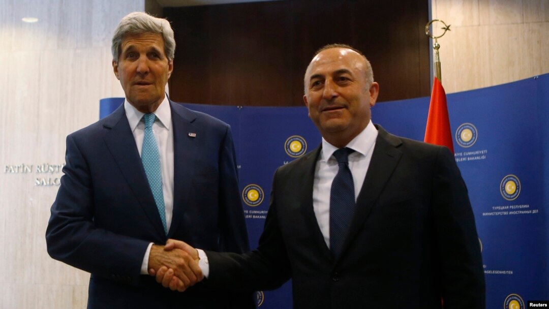 FILE - U.S. Secretary of State John Kerry (L) and Turkey's Foreign Minister Mevlut Cavusoglu pose before a meeting in Ankara, September 12, 2014. 