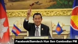 Cambodian Prime Minister Hun Sen holds the ceremonial gavel in a virtual meeting as Cambodia takes over the ASEAN chairmanship, from Brunei, on Thursday, October 28, 2021.