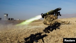 FILE - A U.S. soldier from Dragon Troop of the 3rd Cavalry Regiment fires a Javelin missile system during a training exercise in the Laghman province of Afghanistan, Jan. 1, 2015. 