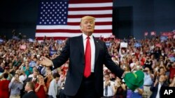 President Donald Trump arrives to speak to a campaign rally at the Ford Center, Aug. 30, 2018, in Evansville, Ind.
