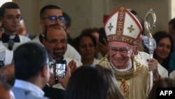 People welcome Vatican Secretary of State Cardinal Pietro Parolin a she arrives to celebrate mass for the dedication and inauguration of the Church of the Baptism of the Lord at Al-Maghtas, 50km west of Amman on the eastern bank of the Jordan River, Jan. 10, 2025. 