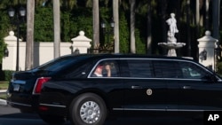 President Donald Trump waves from his limousine as he arrives at his golf club in West Palm Beach, Florida, March 8, 2025. 